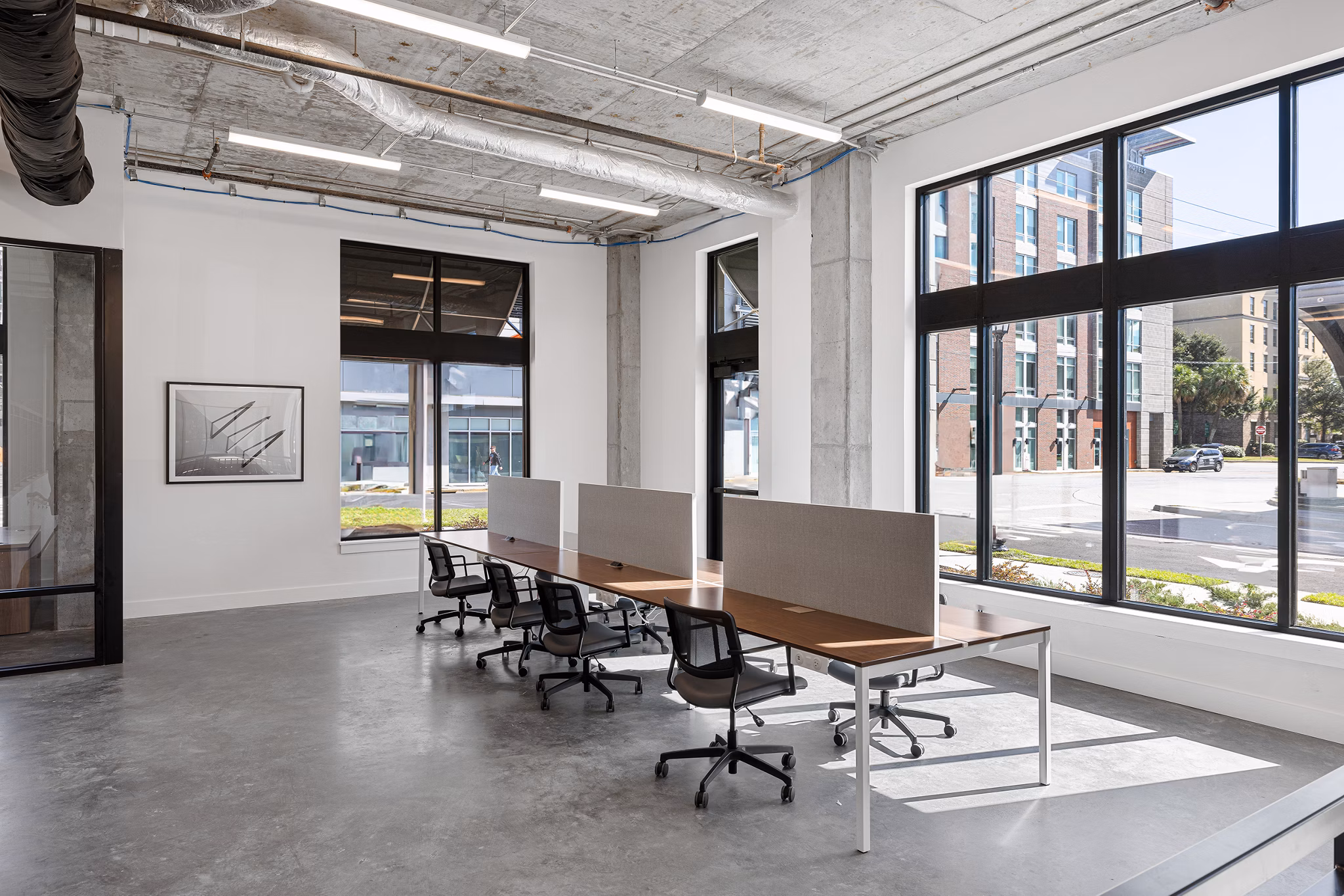 Home office with modern decor and ample natural light at Ann Street Lofts Apartments