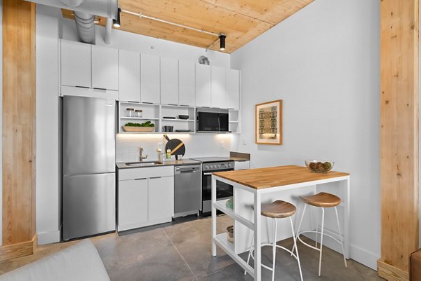 Contemporary kitchen with stainless steel appliances in Ann Street Lofts Apartments