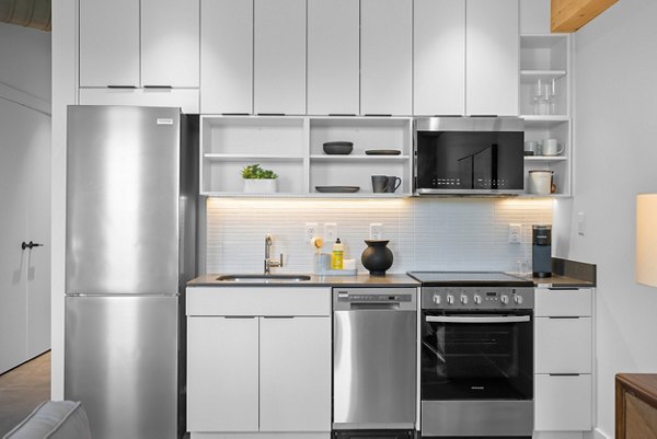 Modern kitchen with stainless steel appliances at Ann Street Lofts Apartments, offering sleek design and functionality