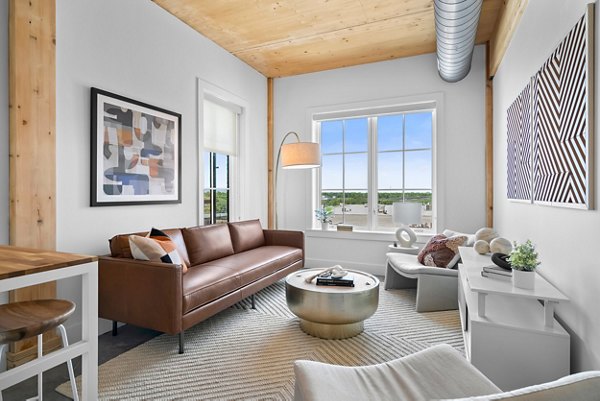 Spacious living room with modern decor in Ann Street Lofts Apartments of luxury Greystar community