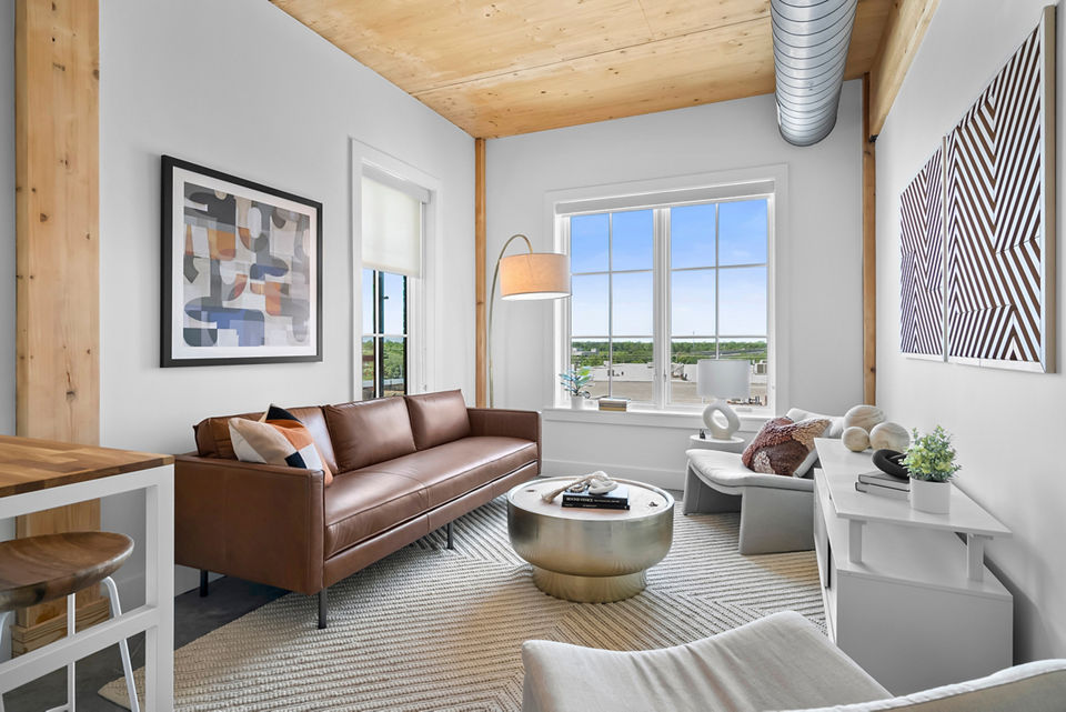 Spacious living room with modern decor in Ann Street Lofts Apartments of luxury Greystar community