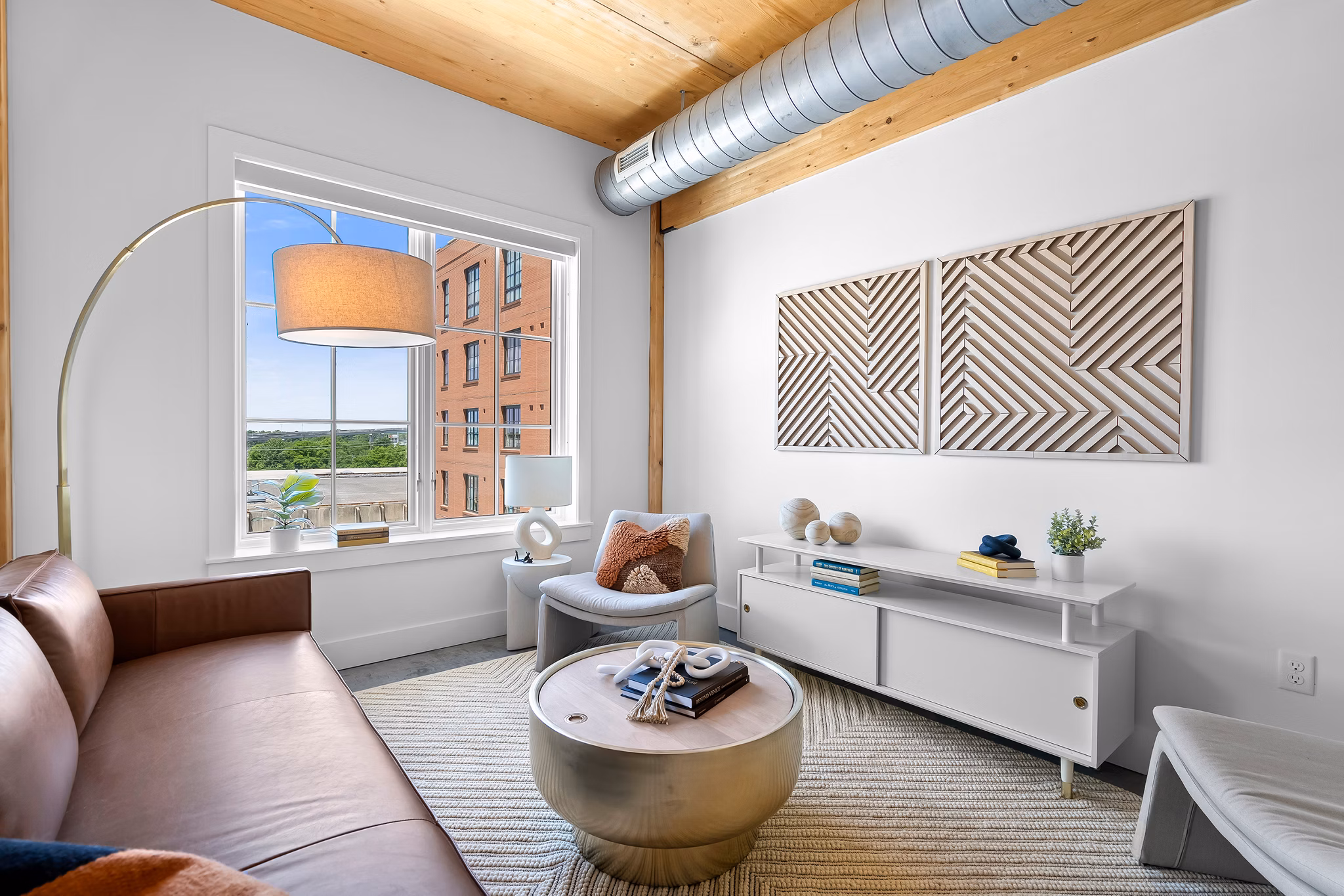 Spacious living room with modern furnishings in Ann Street Lofts Apartments