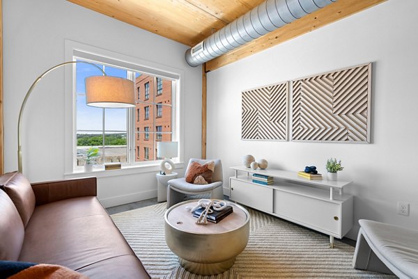 Spacious living room with modern furnishings in Ann Street Lofts Apartments