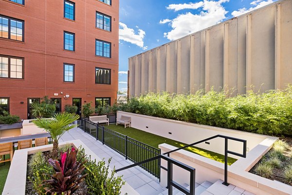 Patio with modern seating and planters at Ann Street Lofts Apartments