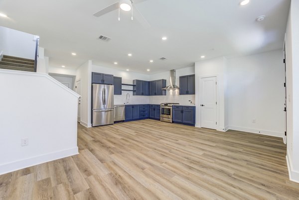 Modern kitchen with stainless steel appliances in Escalon Townhomes Apartments