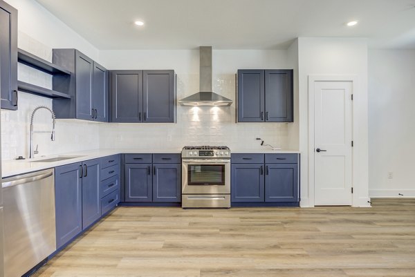 Modern kitchen with stainless steel appliances in Escalon Townhomes Apartments Ideal for cooking enthusiasts seeking luxury and style