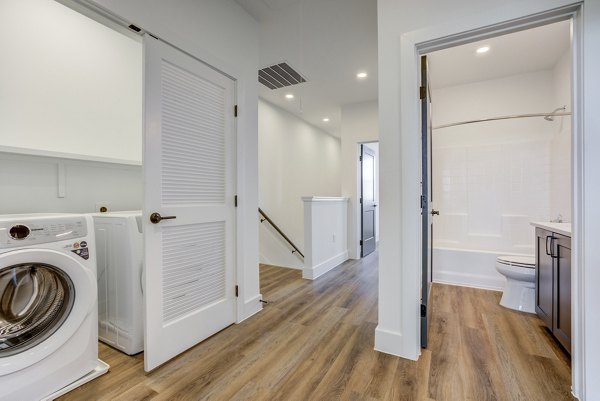 Laundry room with modern appliances at Escalon Townhomes Apartments