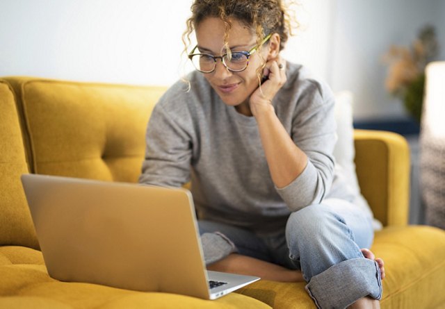 Girl Apartment Browsing on Couch | Blog | Greystar