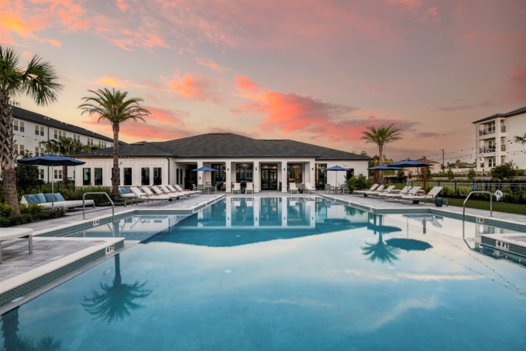 photo of the champions ridge pool and clubhouse at sunset