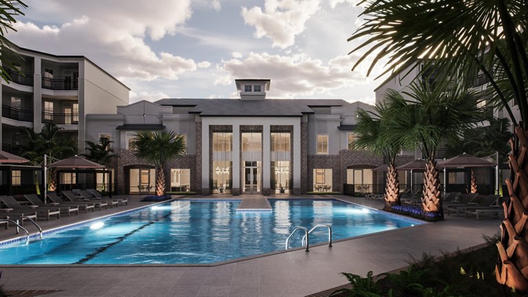 A tranquil evening view of a resort-style pool flanked by palm trees and sun loungers in front of an elegant building facade.