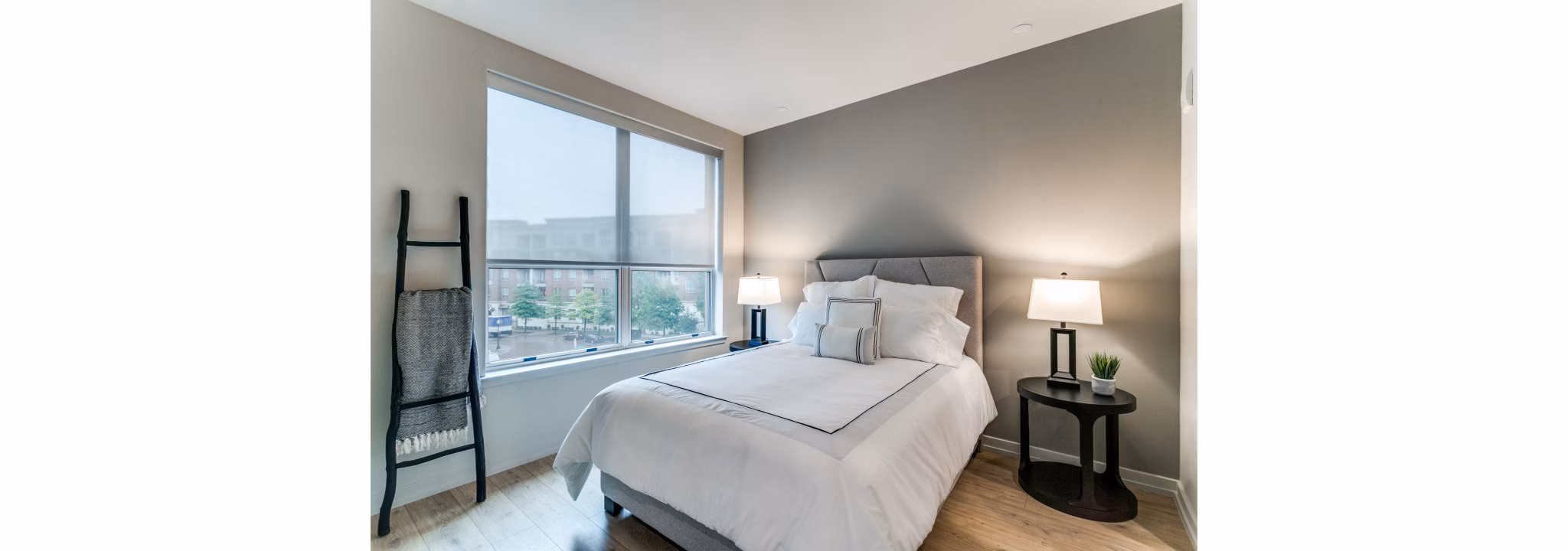 Cozy bedroom with plush bedding and modern decor in 3700M Apartments luxury community