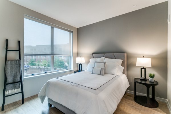 Cozy bedroom with plush bedding and modern decor in 3700M Apartments luxury community