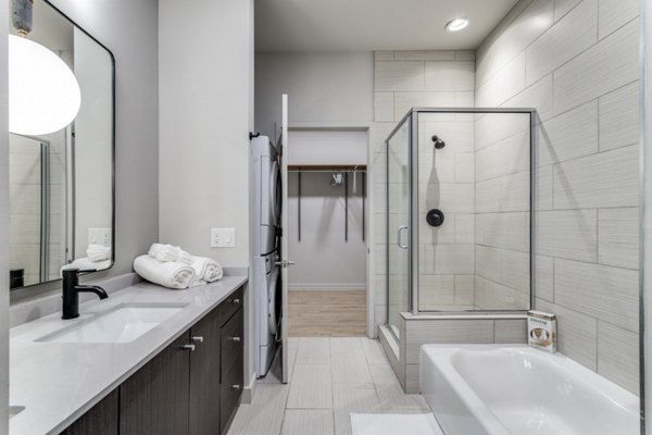 Luxury bathroom with marble countertops and glass shower at 3700M Apartments