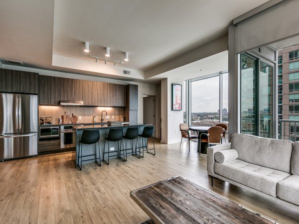 Modern kitchen with sleek countertops and stainless appliances in 3700M Apartments