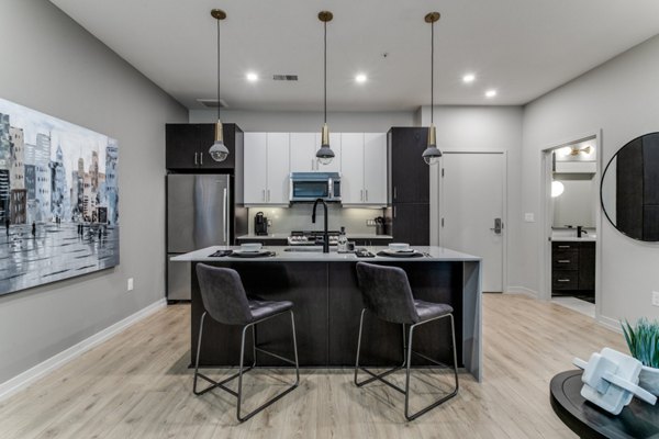 Modern kitchen with stainless steel appliances in 3700M Apartments