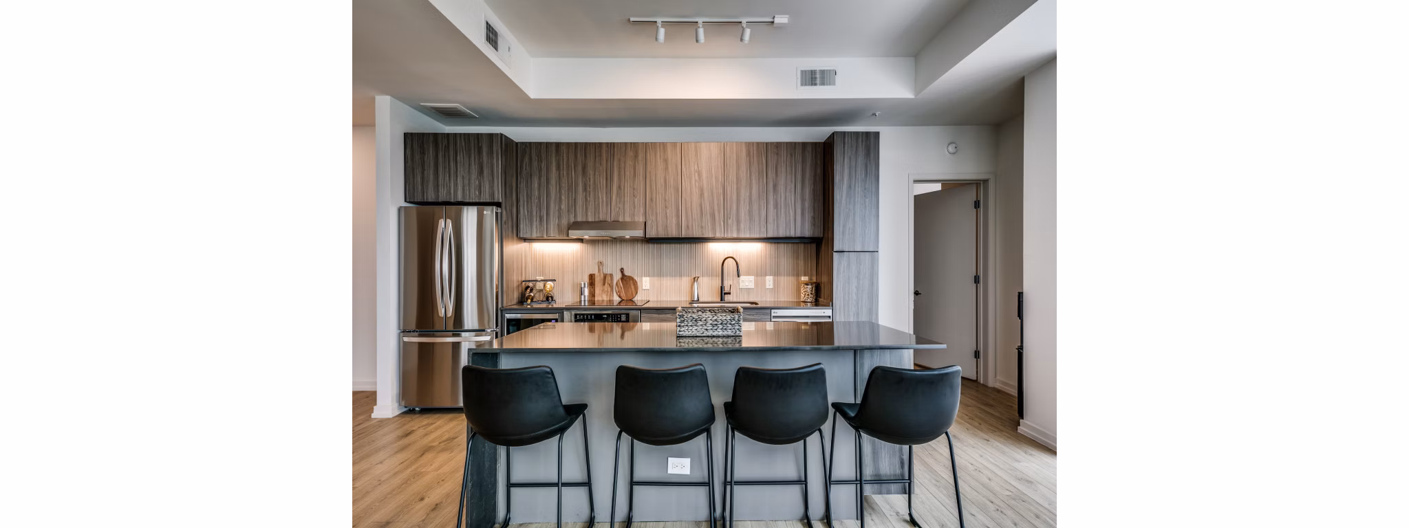 Sleek kitchen with stainless steel appliances at 3700M Apartments, highlighting luxury living for urban dwellers
