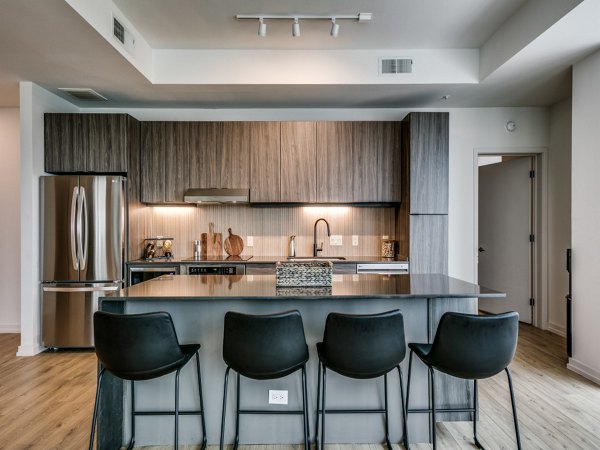 Sleek kitchen with stainless steel appliances at 3700M Apartments, highlighting luxury living for urban dwellers