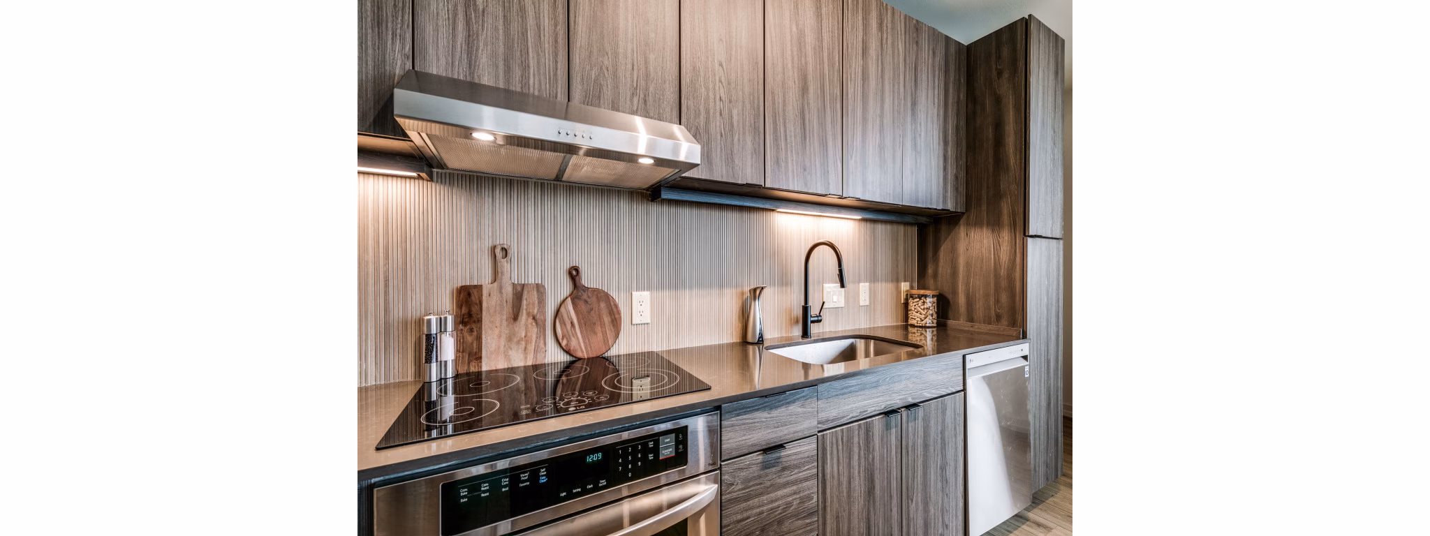 Modern kitchen with sleek appliances and granite countertops at 3700M Apartments, a luxury Greystar property