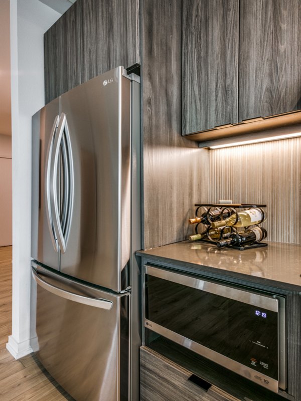 Modern kitchen with sleek cabinetry and stainless steel appliances at 3700M Apartments in vibrant urban setting