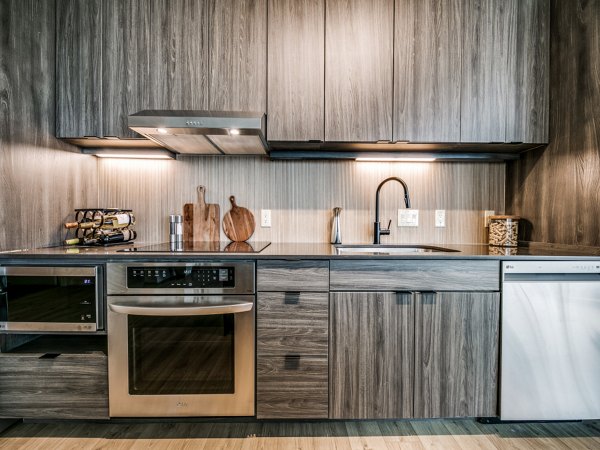 Contemporary kitchen with sleek cabinetry and stainless steel appliances at 3700M Apartments