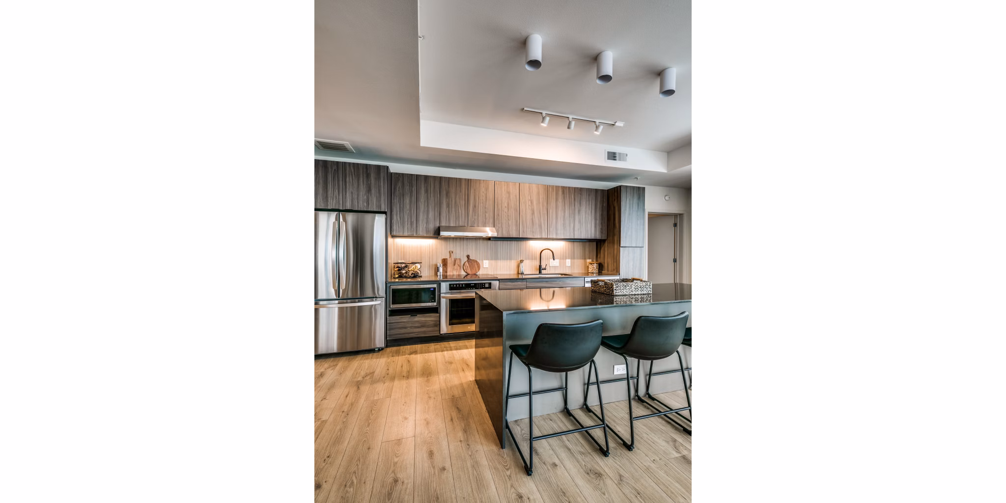 Modern kitchen with stainless steel appliances at 3700M Apartments