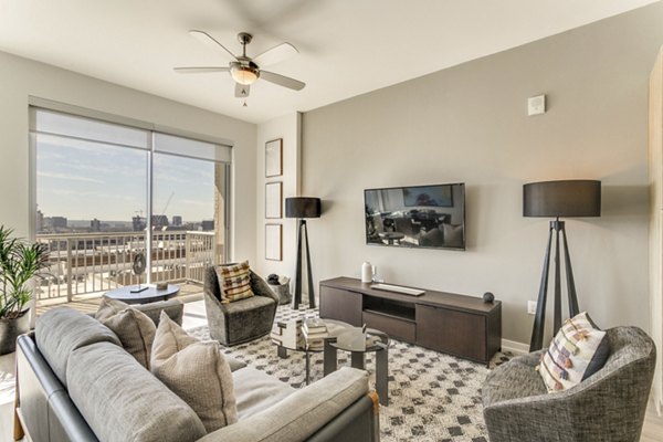 Spacious living room with modern furnishings at 3700M Apartments, featuring luxury amenities and elegant design