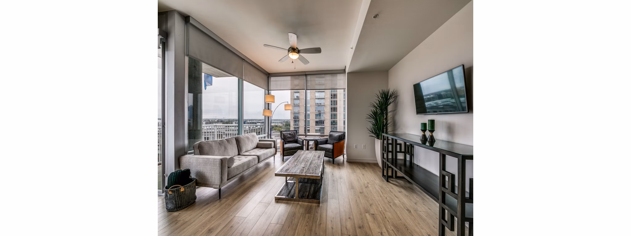 Modern living room with sleek furniture and large windows at 3700M Apartments, showcasing luxury urban design in a vibrant community
