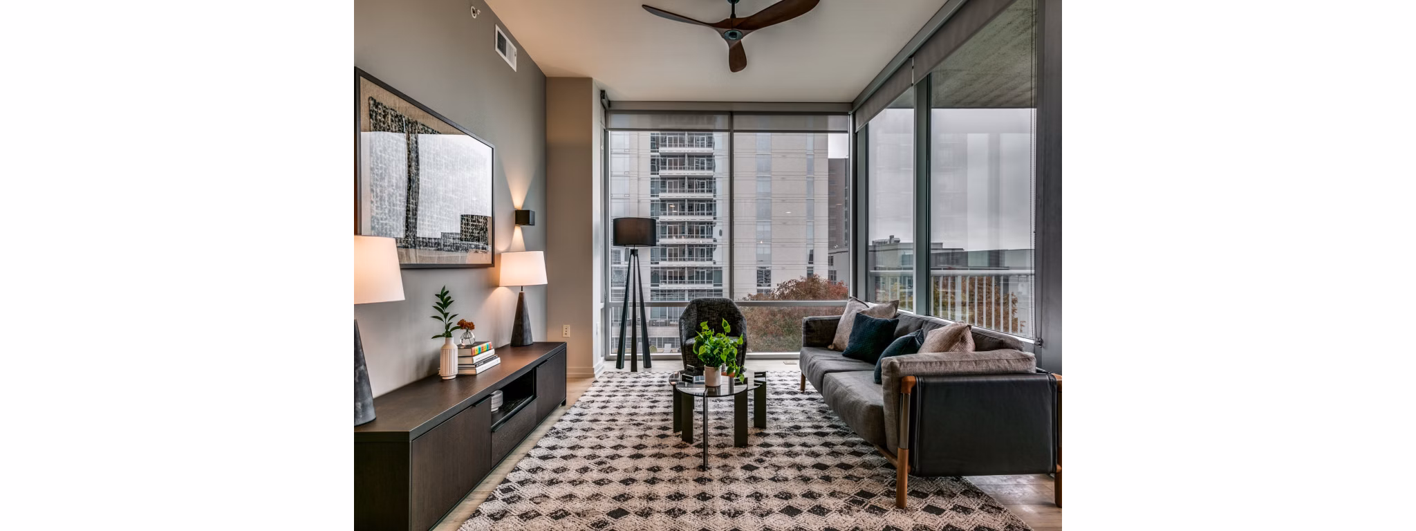Spacious living room with modern decor and large windows in 3700M Apartments