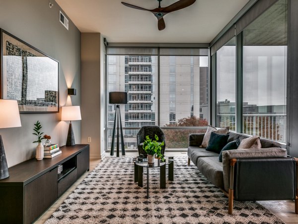 Spacious living room with modern decor and large windows in 3700M Apartments