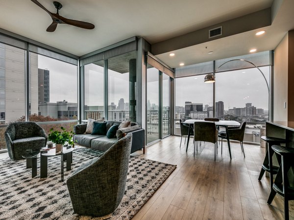 Spacious living room with modern decor and large windows in 3700M Apartments, offering luxury city living