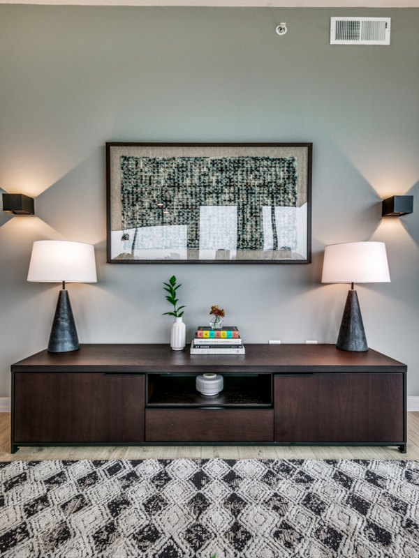 Spacious living room with modern furnishings and large windows in 3700M Apartments