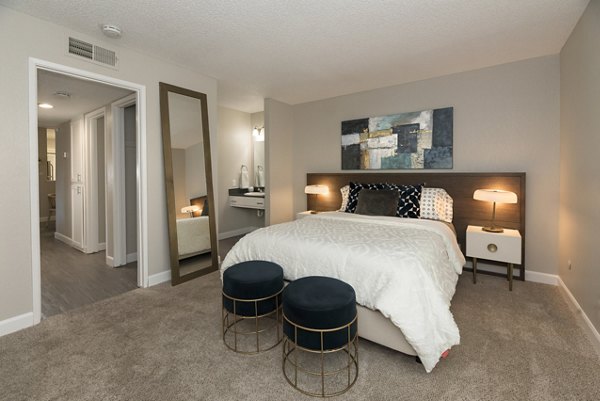 Cozy bedroom with modern decor at The Hills Apartments, a luxury property by Greystar