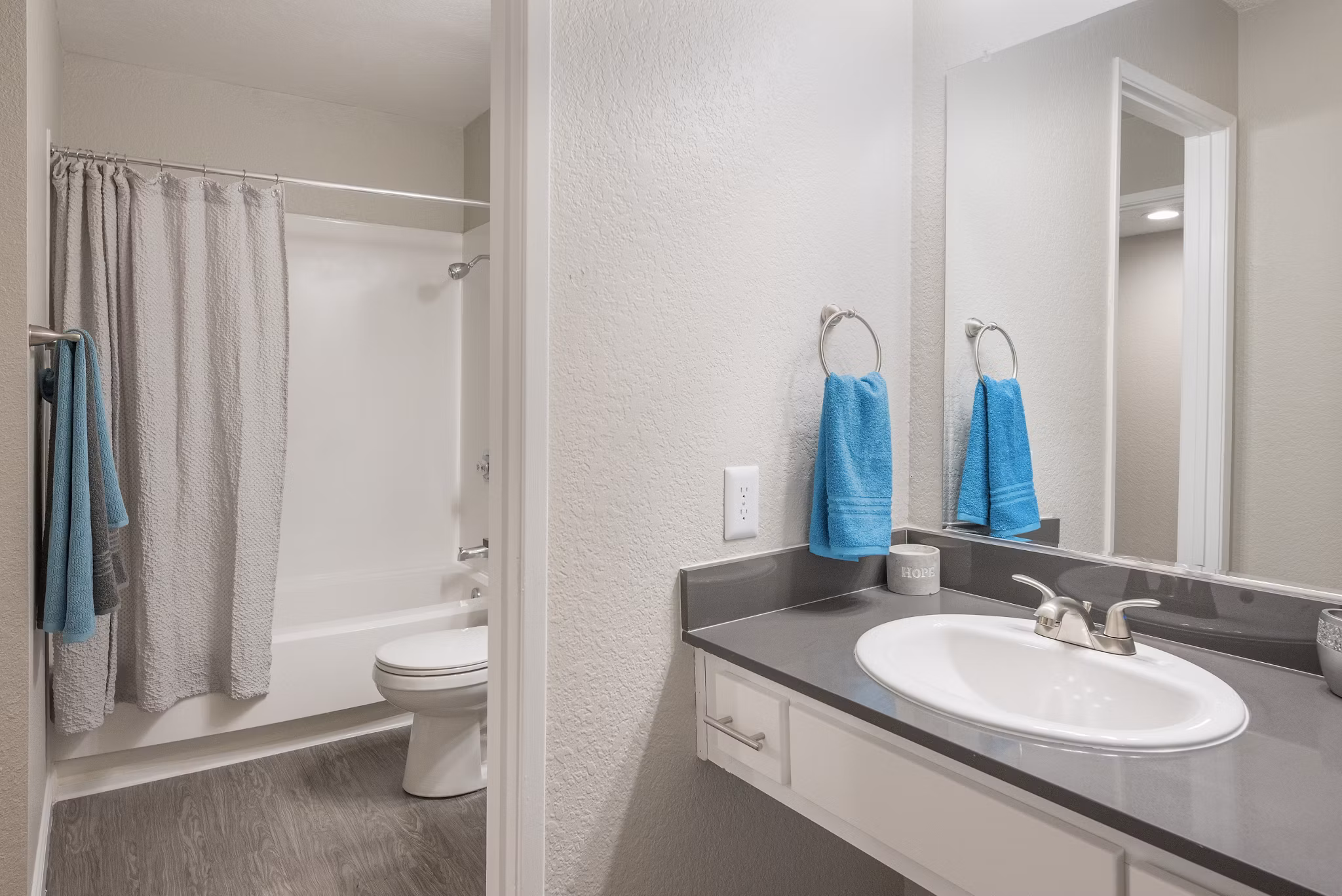 The Hills Apartments: Modern bathroom with sleek fixtures and marble countertops
