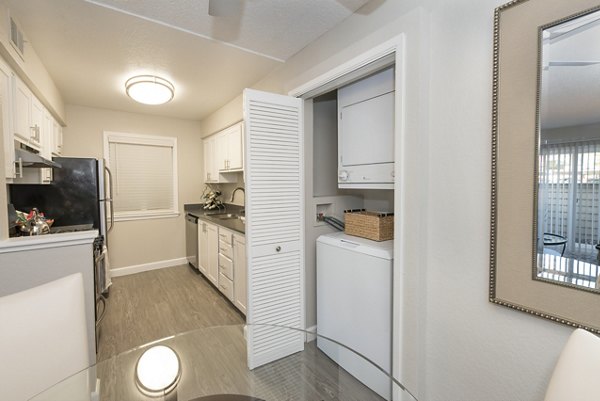 Dining area with elegant wood furnishings at The Hills Apartments: Luxury living space in a premier Greystar community