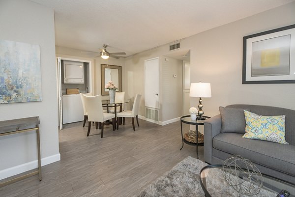 Spacious living room with modern decor at The Hills Apartments, offering comfort and style for residents