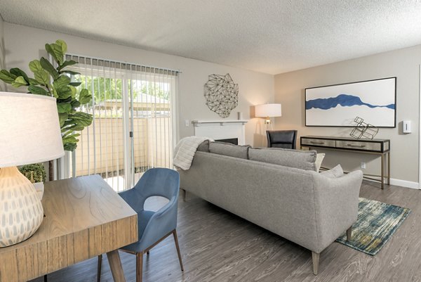 Cozy living room with a modern design at The Hills Apartments, featuring plush seating and elegant decor