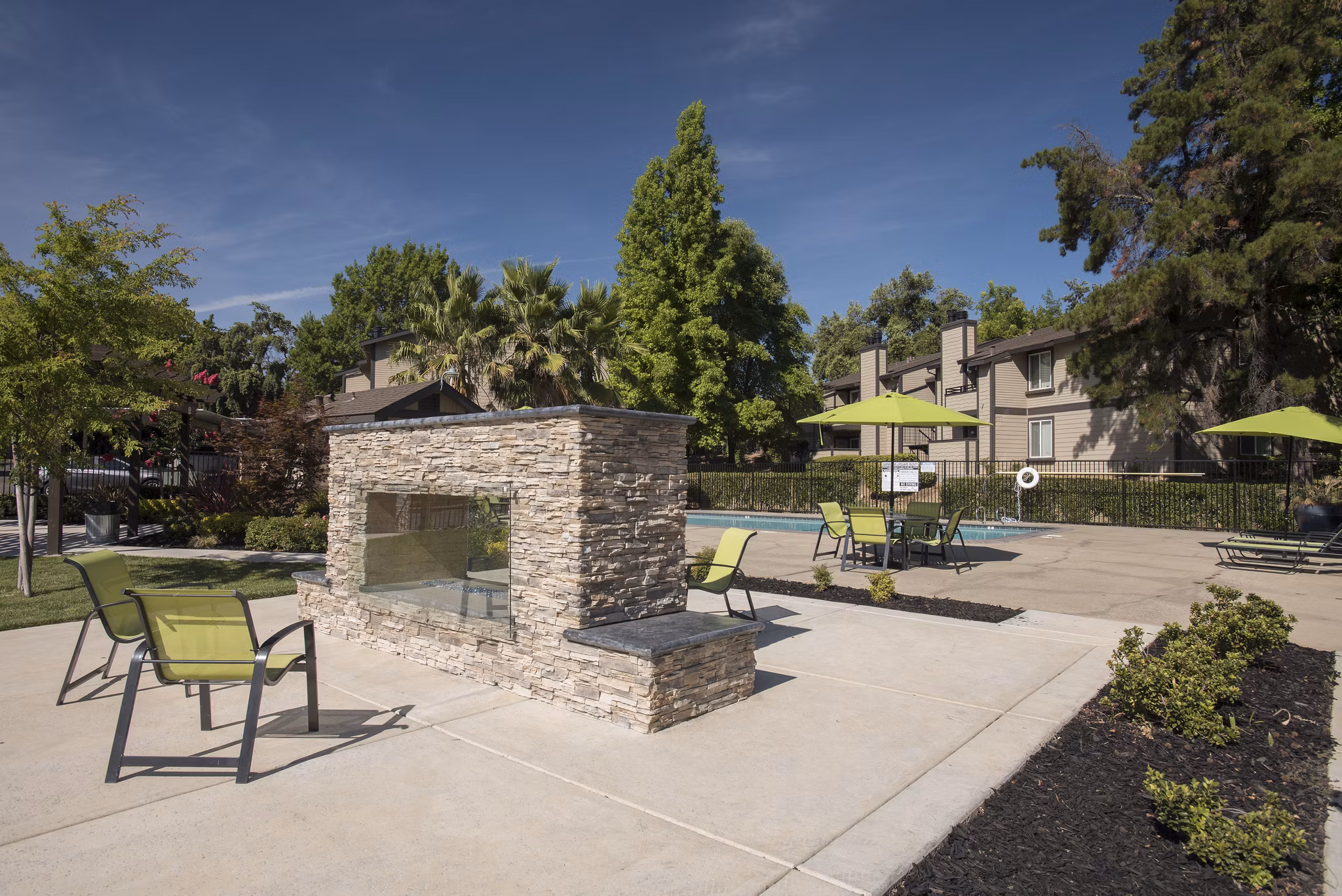 The Hills Apartments: Cozy fire pit area in a tranquil outdoor setting