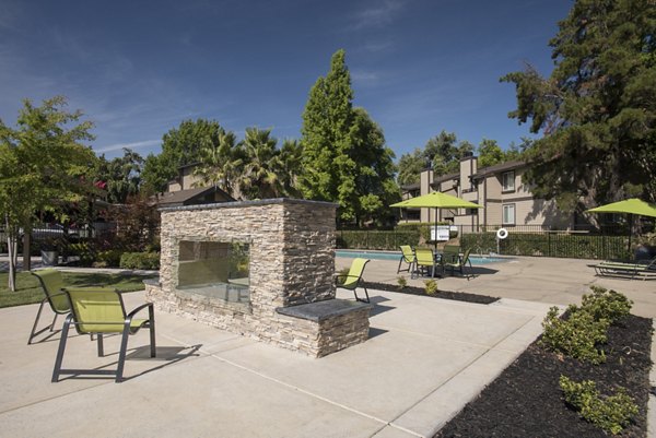 The Hills Apartments: Cozy fire pit area in a tranquil outdoor setting