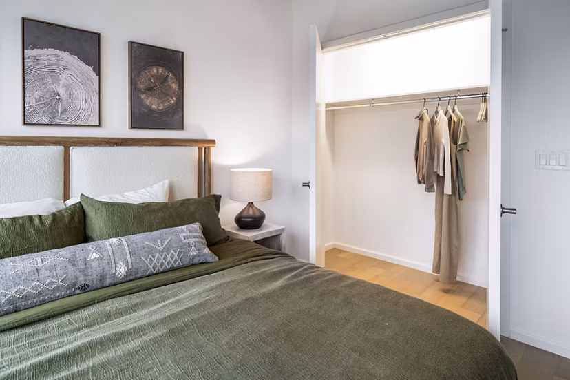 Modern bedroom with city skyline view at 1111 Church Apartments