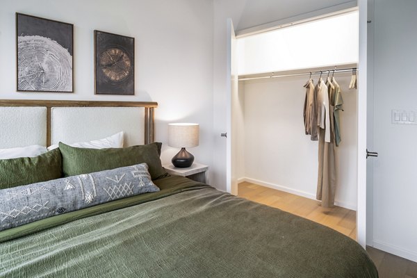 Modern bedroom with city skyline view at 1111 Church Apartments