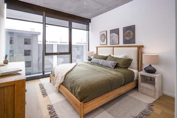 Cozy bedroom with modern furnishings at 1111 Church Apartments
