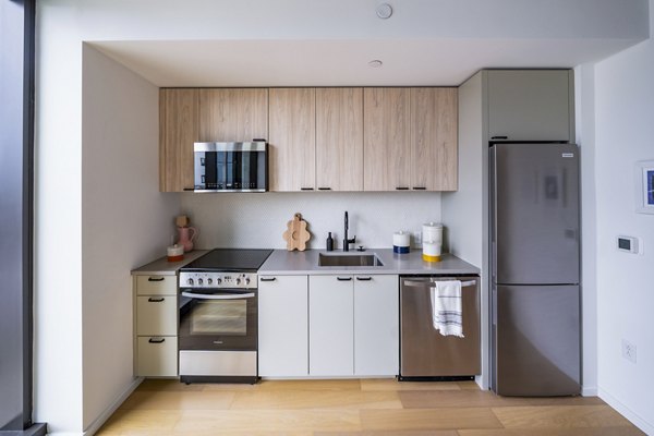 Modern kitchen with stainless steel appliances at 1111 Church Apartments