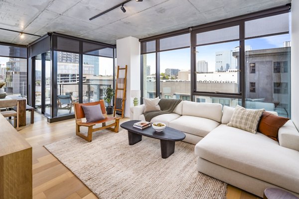 Living room with modern furnishings and natural light at 1111 Church Apartments