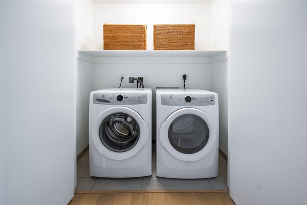 Convenient laundry room with modern appliances at 1111 Church Apartments