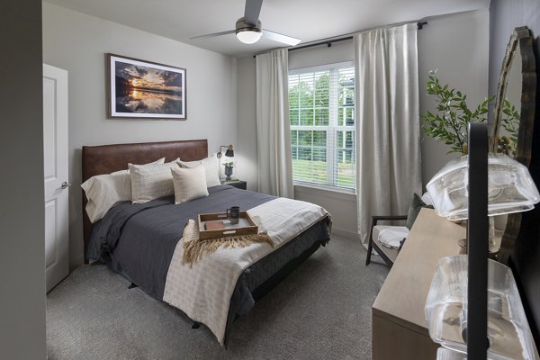 Stylish bedroom with modern decor at Elan Sweetwater Creek Apartments, offering luxury living in a serene setting