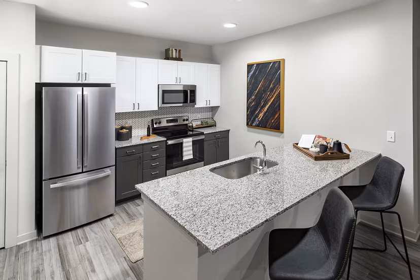 Modern kitchen with stainless steel appliances in Elan Sweetwater Creek Apartments