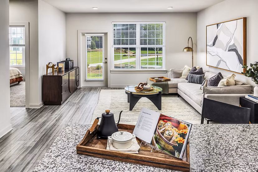 Living room with modern furnishings at Elan Sweetwater Creek Apartments, featuring a cozy lounge area and vibrant decor