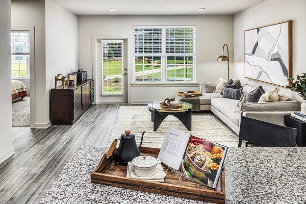 Living room with modern furnishings at Elan Sweetwater Creek Apartments, featuring a cozy lounge area and vibrant decor