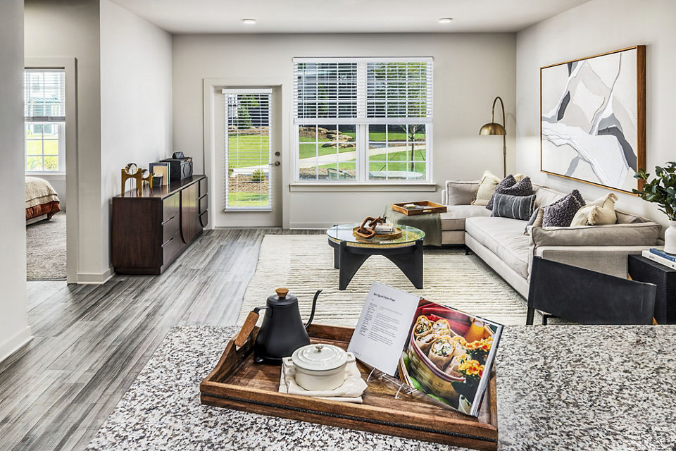 Living room with modern furnishings at Elan Sweetwater Creek Apartments, featuring a cozy lounge area and vibrant decor