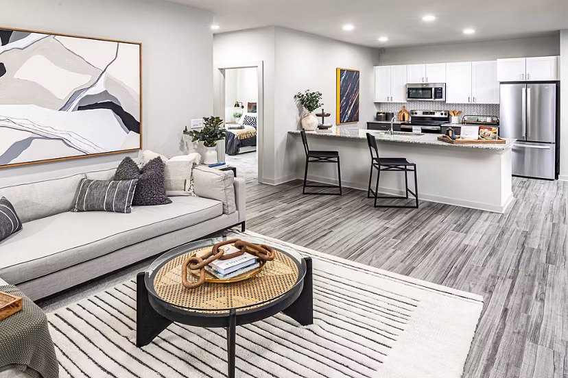 Bright living room with contemporary decor at Elan Sweetwater Creek Apartments, offering luxury and comfort in every detail